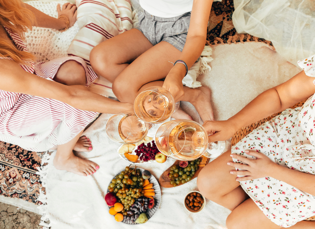 Crop Women Drinking Wine during Picnic